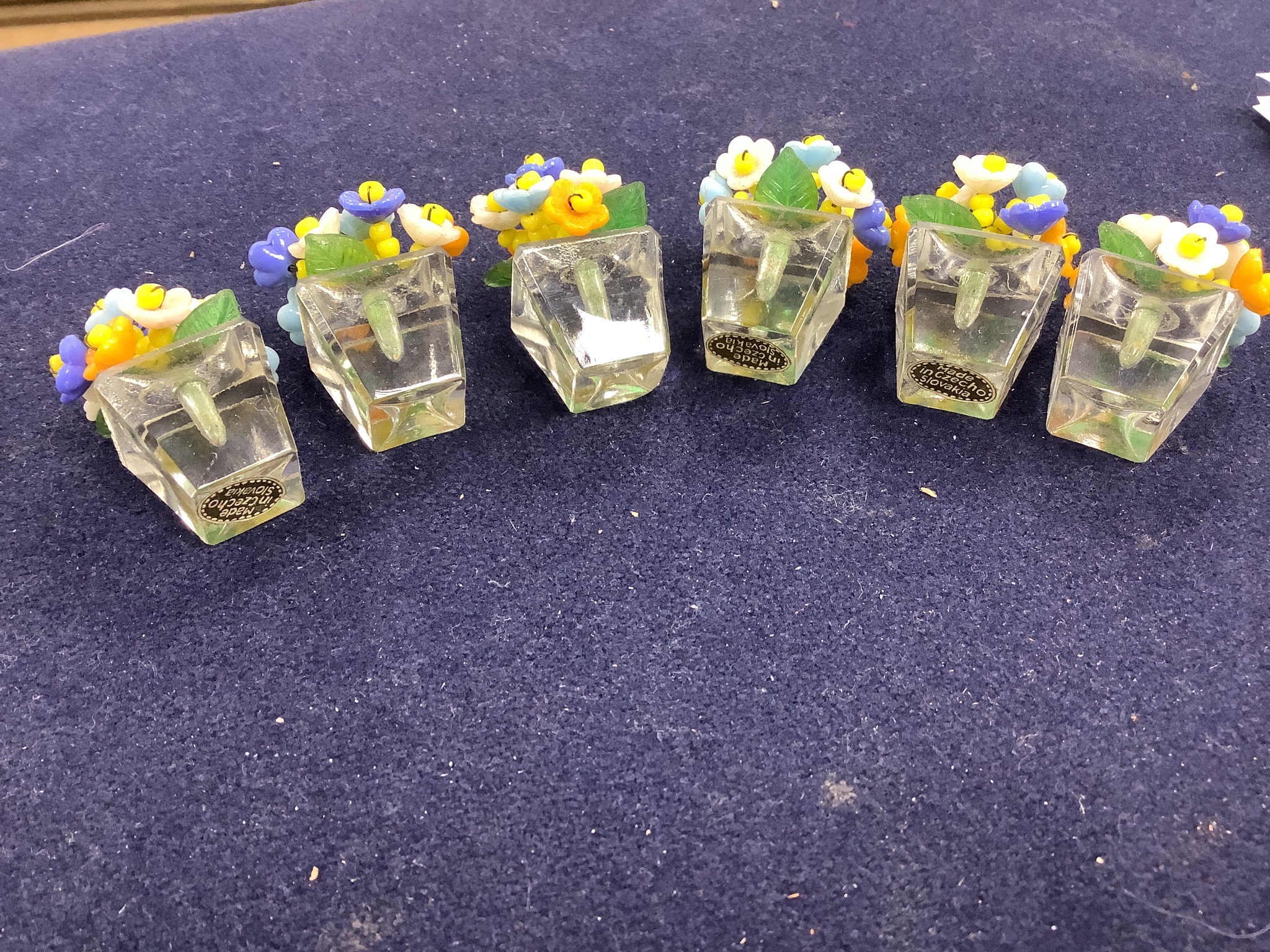 A boxed set of six Czechoslovakian glass flower menu holders, height 3.5cm